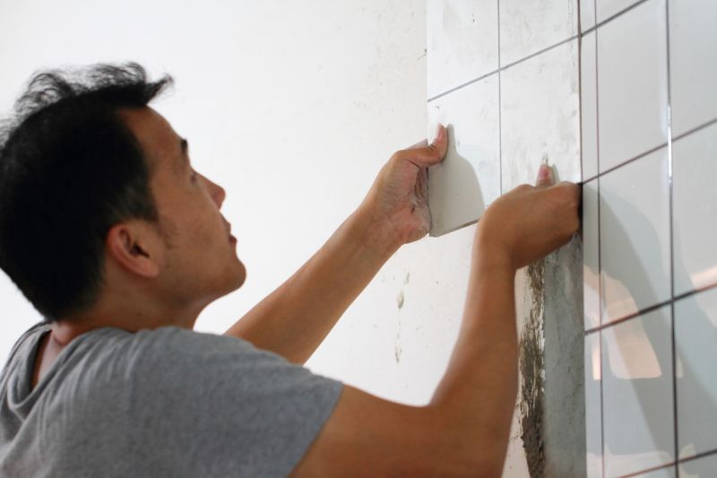 Expert tile installer working on a bathroom