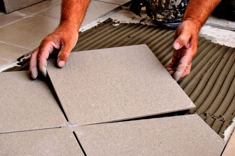 Professional laying tiles in a kitchen